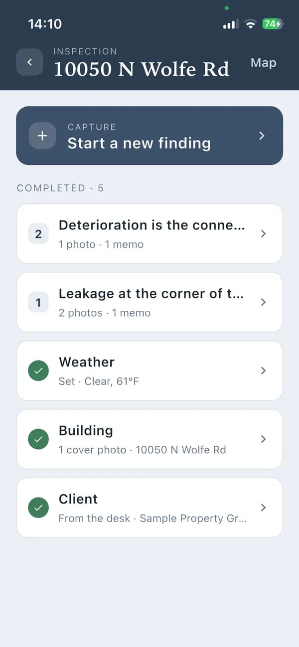 The iPhone app's inspection checklist, with two findings captured.
